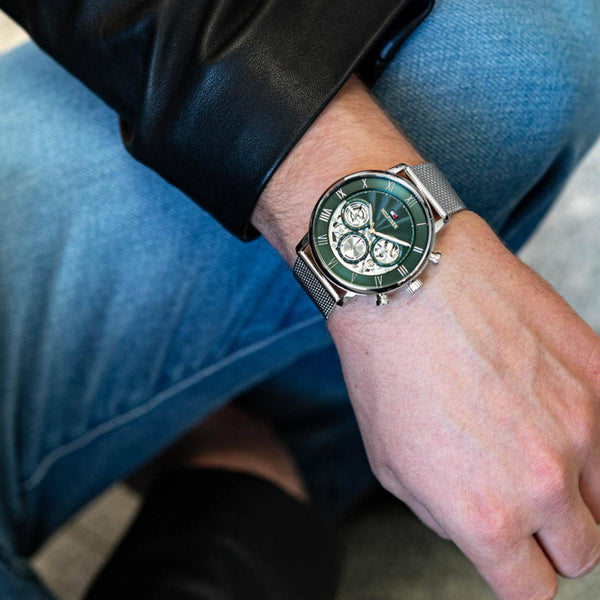 Tommy Hilfiger Legend watch worn on wrist showing green dial with chronograph subdials