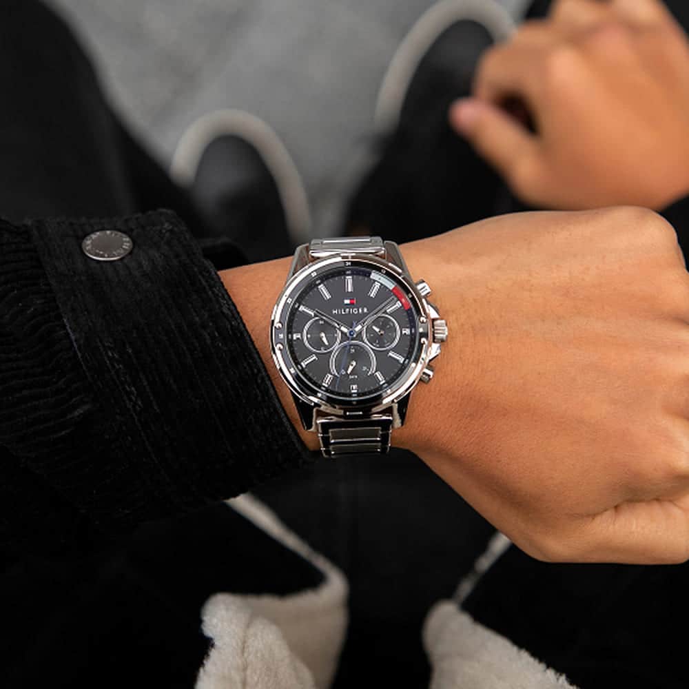 Tommy Hilfiger Mason watch worn on wrist with black dial and steel bracelet