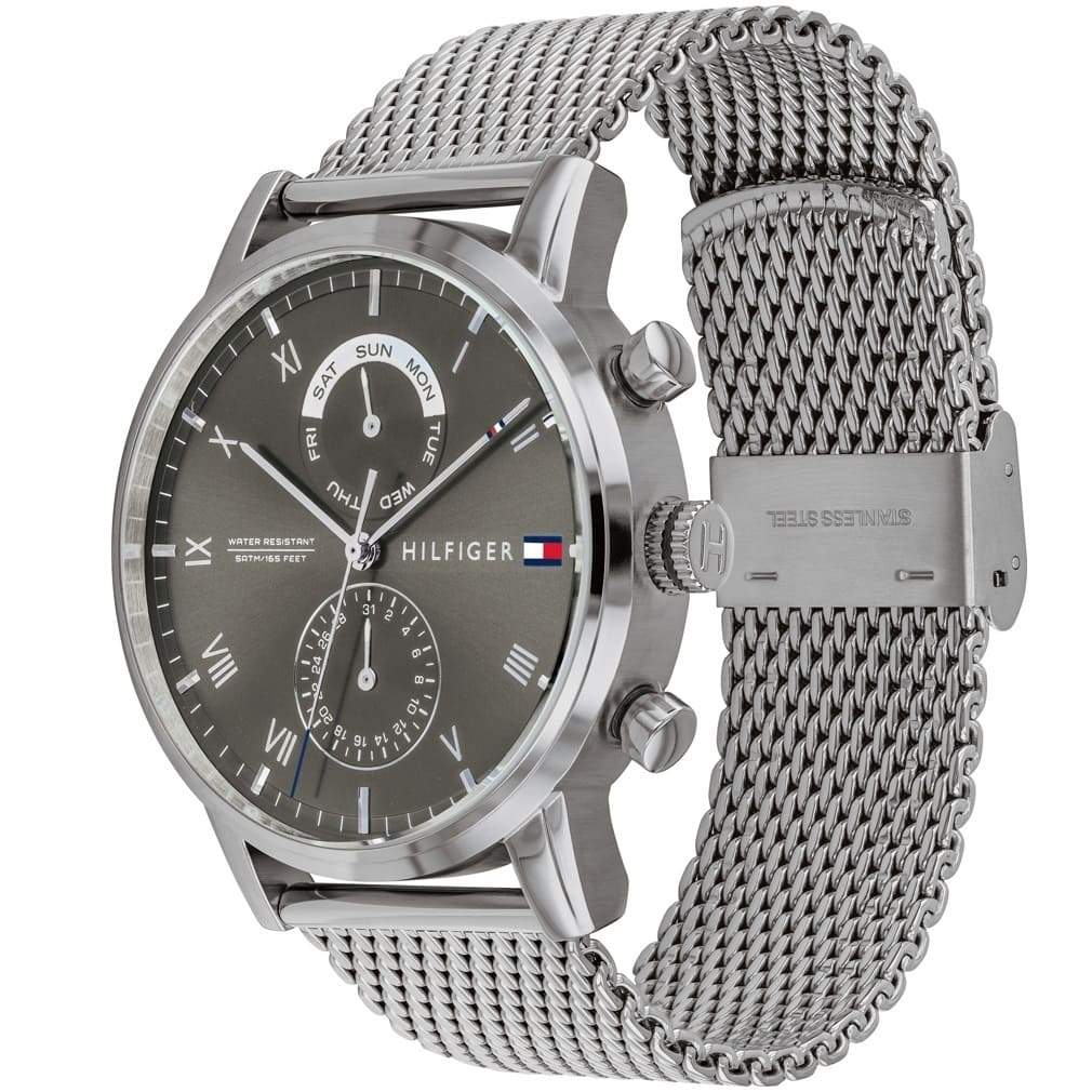 Side angled view of Tommy Hilfiger chronograph watch showing stainless steel mesh bracelet detail