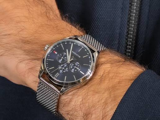 Tommy Hilfiger Oliver quartz watch worn on wrist with silver mesh bracelet