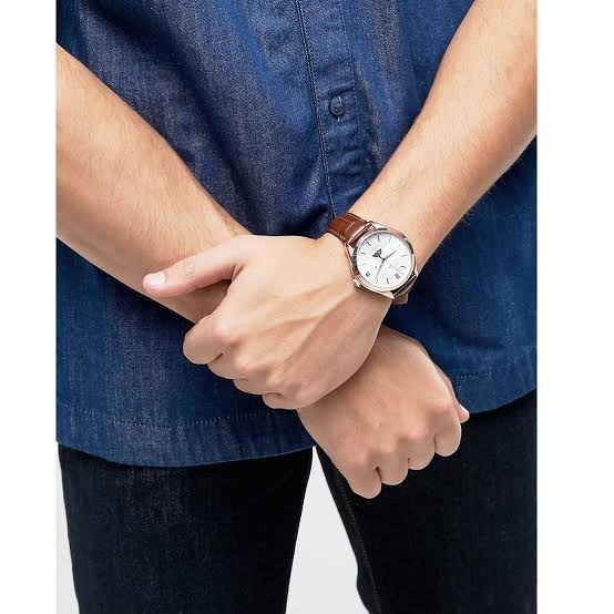 Tommy Hilfiger Oliver watch worn on male wrist with denim shirt, brown leather strap and rose gold case