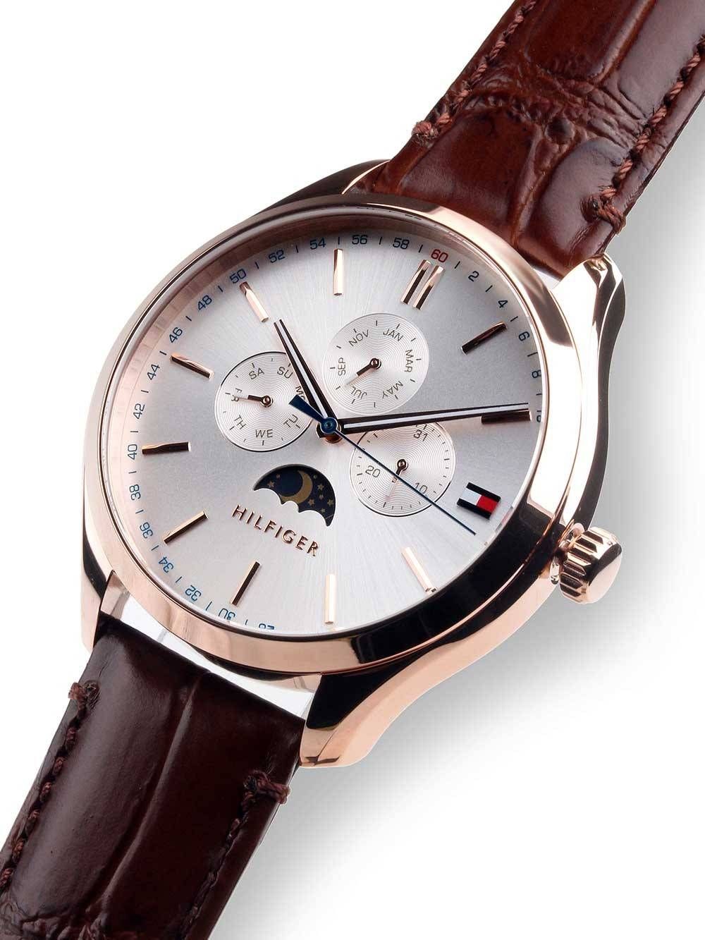 Side view of Tommy Hilfiger Oliver watch with rose gold case, moon phase dial, and brown leather strap