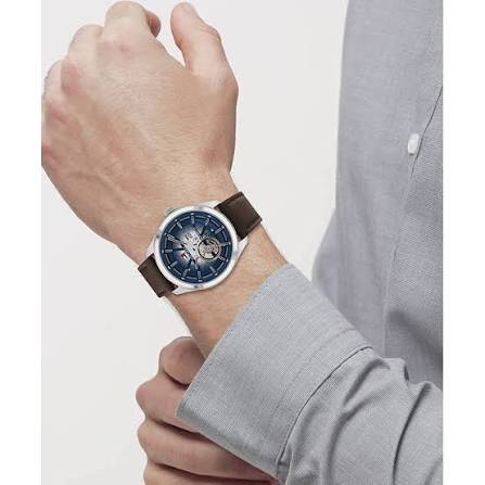 Tommy Hilfiger Oliver watch worn on wrist with blue dial and brown leather strap