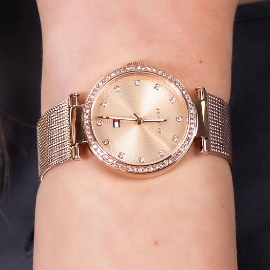 Tommy Hilfiger rose gold women's watch worn on wrist with crystal bezel and mesh band