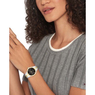 Tommy Hilfiger Serein women's watch worn on wrist with black dial and two-tone bracelet