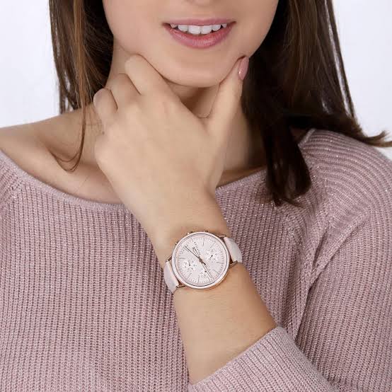 Tommy Hilfiger Sport women's watch worn on wrist with pink dial and white leather strap