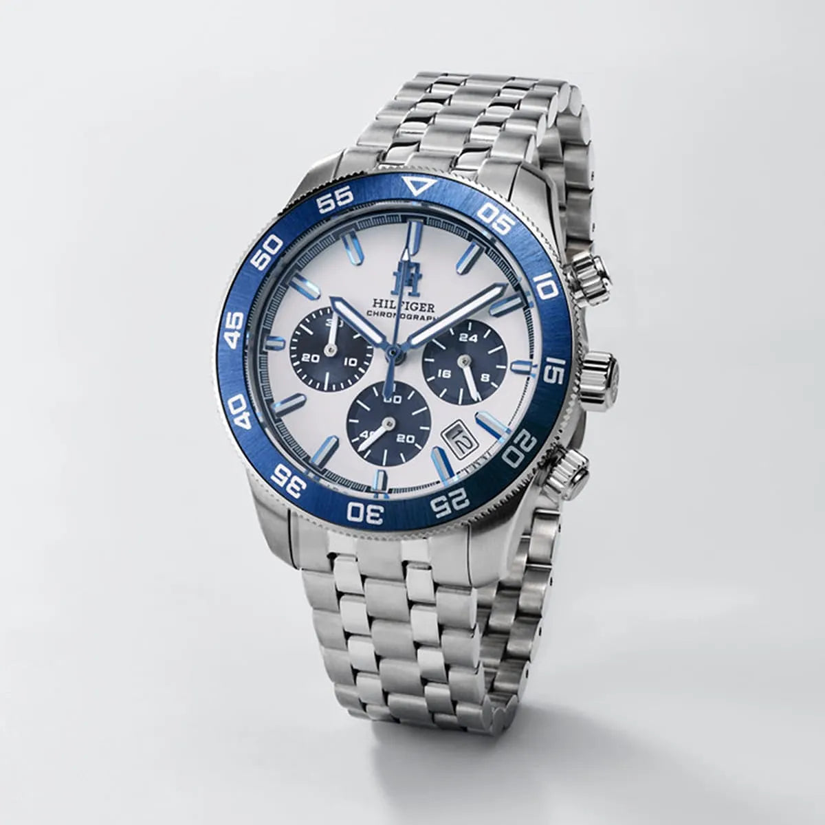 Tommy Hilfiger TH85 chronograph with white dial, blue bezel, and stainless steel bracelet