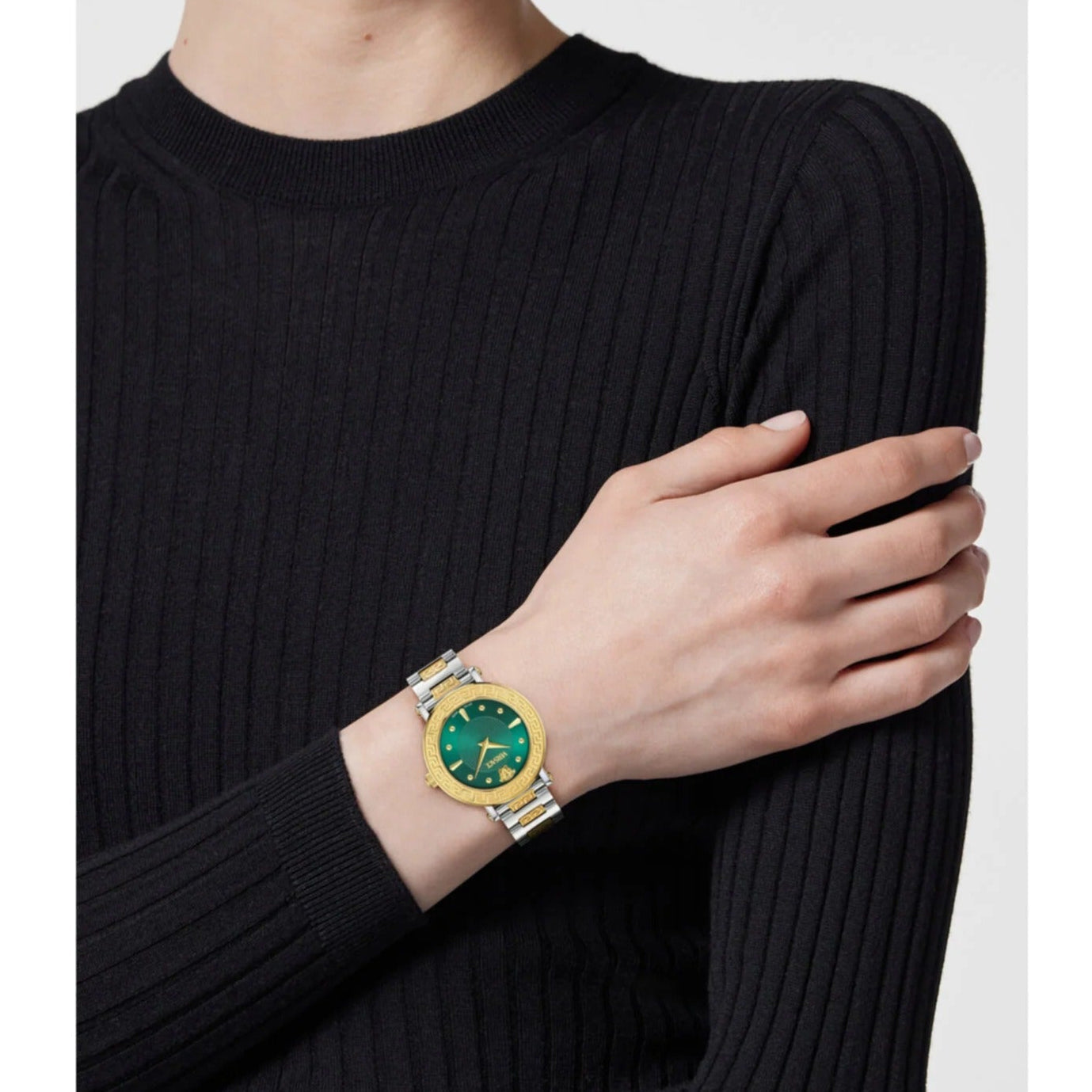 Versace Daphnis watch worn on wrist showing green dial and two-tone stainless steel design