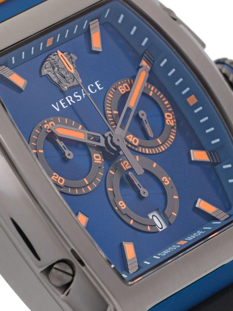 Close-up of Versace Dominus blue dial with orange chronograph subdials, hour markers, and Versace logo