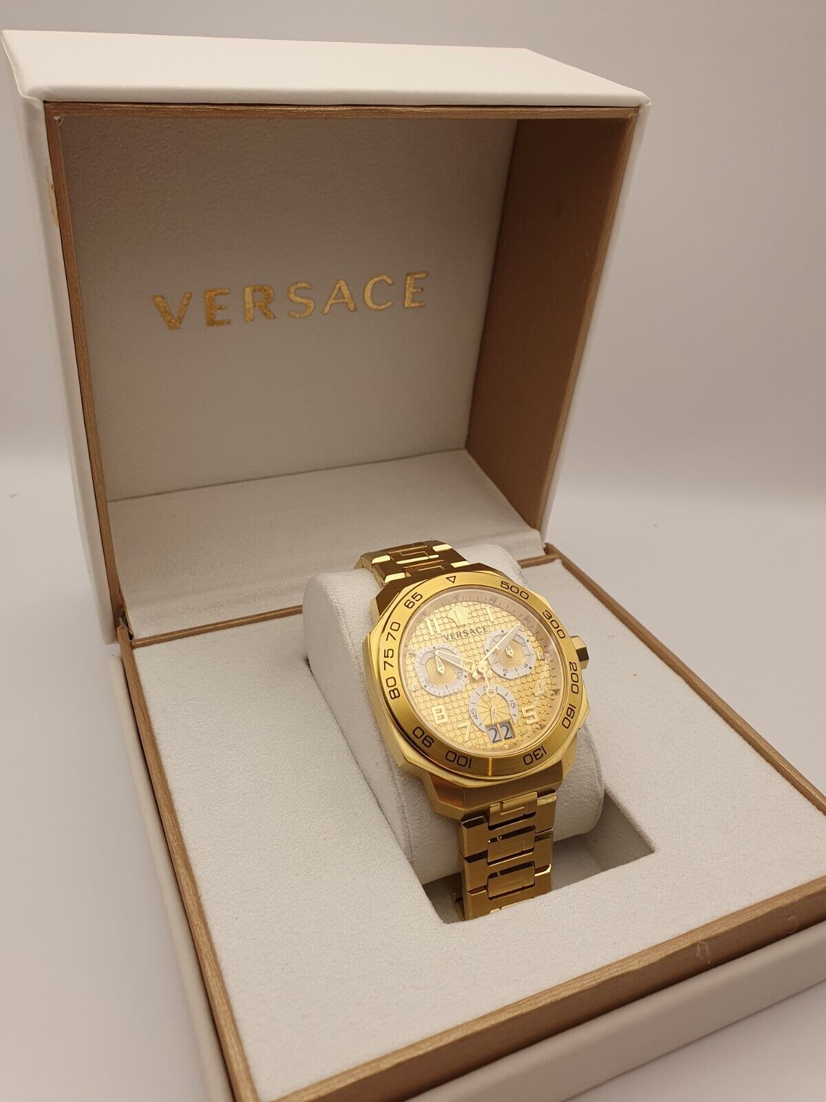 Versace Dylos gold chronograph watch displayed in Versace branded box
