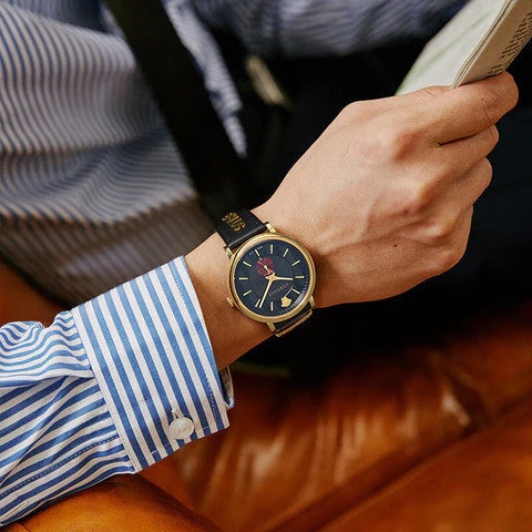 Versace V-Circle Manifesto watch worn on wrist with striped shirt cuff