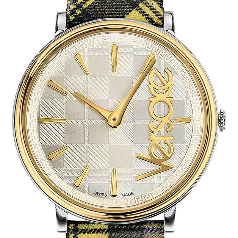 Close-up of Versace V-Race dial showing gold-tone markers, Versace script logo, and Greek key pattern bezel
