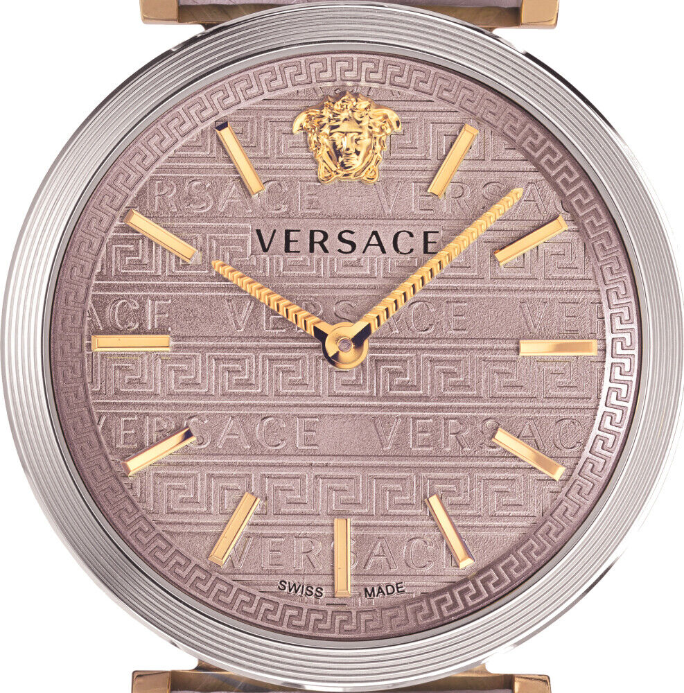 Versace V-Twist dial detail with light pink face, Medusa logo, Greek key pattern, gold-tone indices and hands