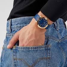 Versace V-Urban watch worn on wrist showing blue dial and gold-tone case