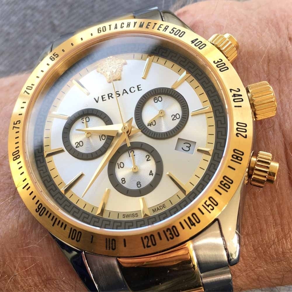Versace chronograph watch worn on wrist showing dial detail with subdials and gold-tone bezel