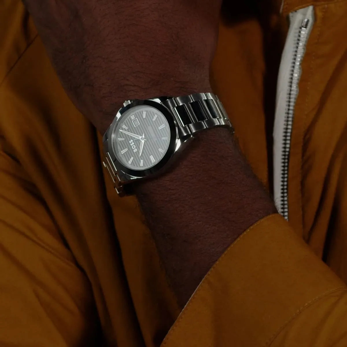 Hugo Boss Skymaster timepiece on wrist showing black dial and stainless steel bracelet in wear