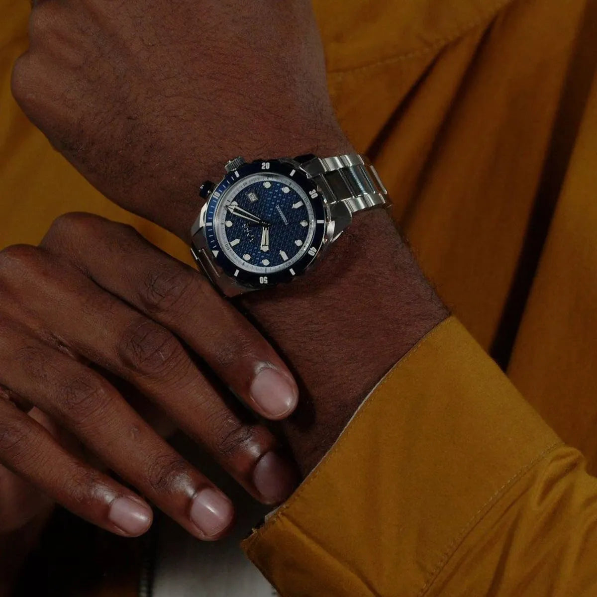 Hugo Boss Skymaster automatic watch on wrist displaying blue dial and stainless steel case
