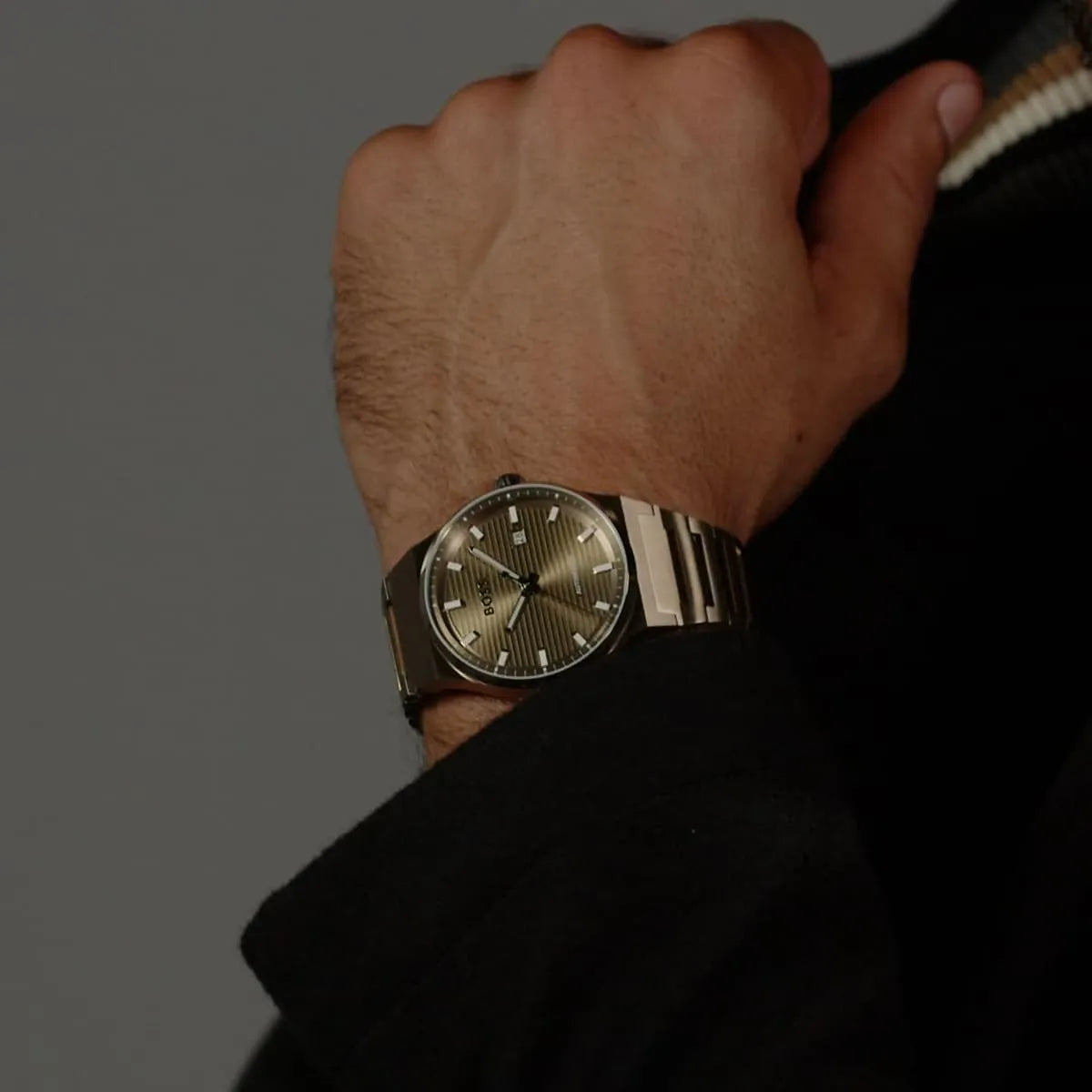 Hugo Boss Skymaster watch worn on wrist showing green dial and stainless steel case