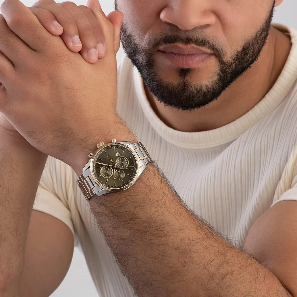 Man wearing Hugo BOSS Grand Prix watch with two-tone green dial chronograph on wrist