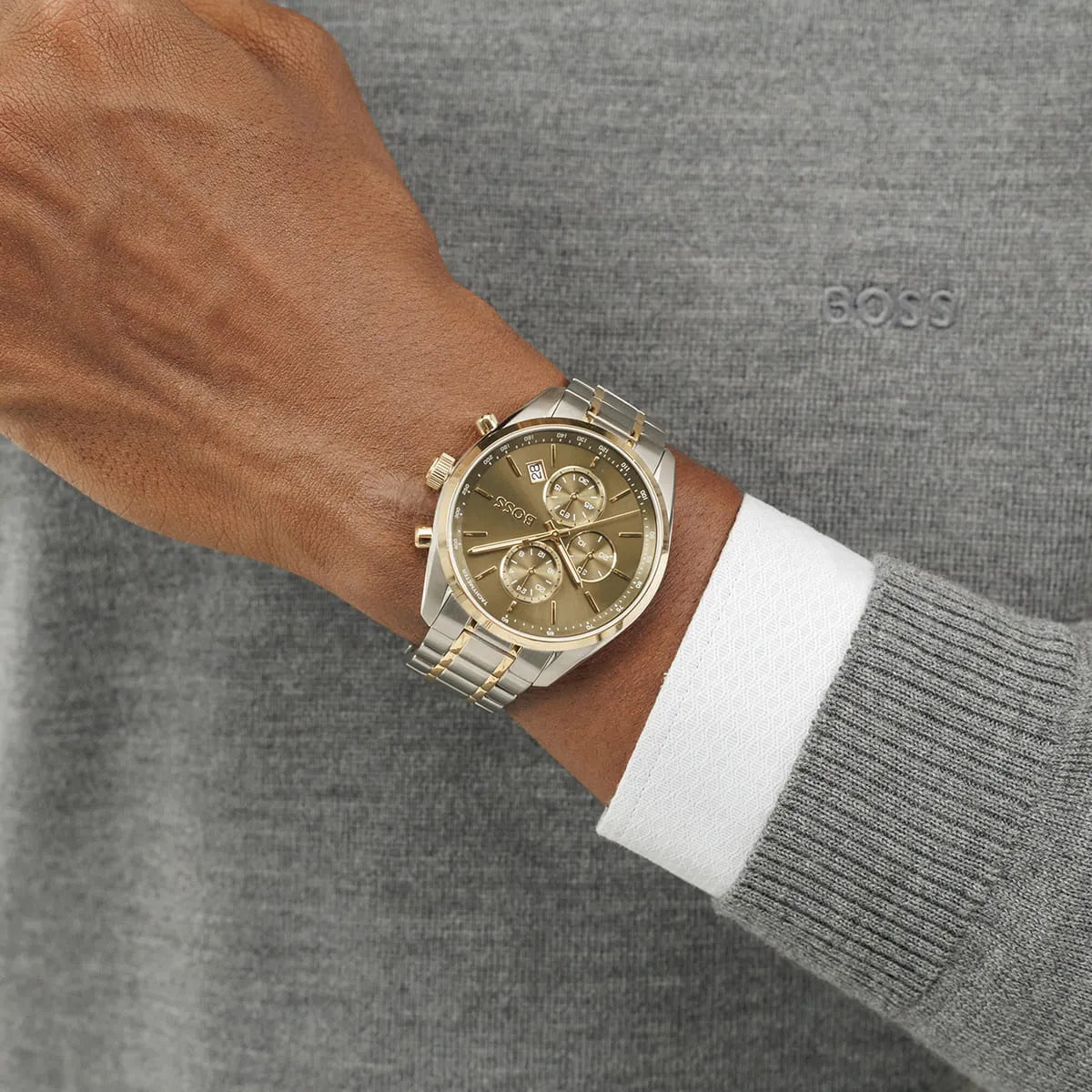 Hugo BOSS Grand Prix chronograph watch worn on wrist with two-tone bracelet and green face