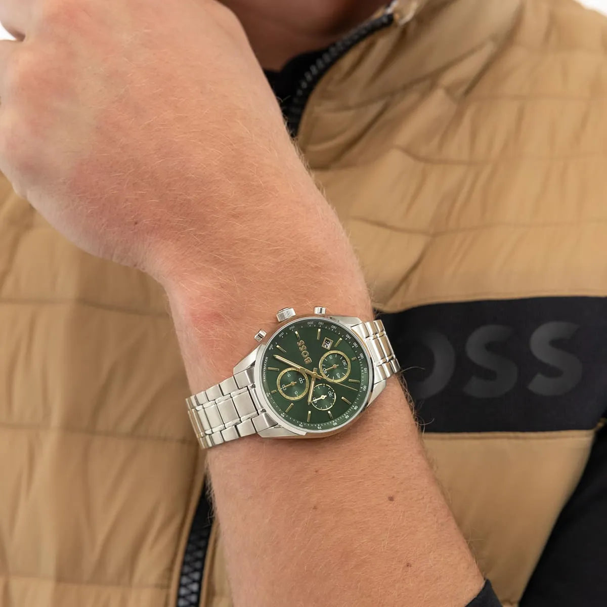 Hugo Boss Grand Prix chronograph watch worn on wrist showing green dial with gold accents
