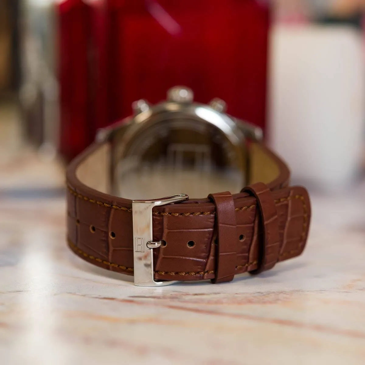 Tommy Hilfiger Sawyer watch displayed with red gift box packaging