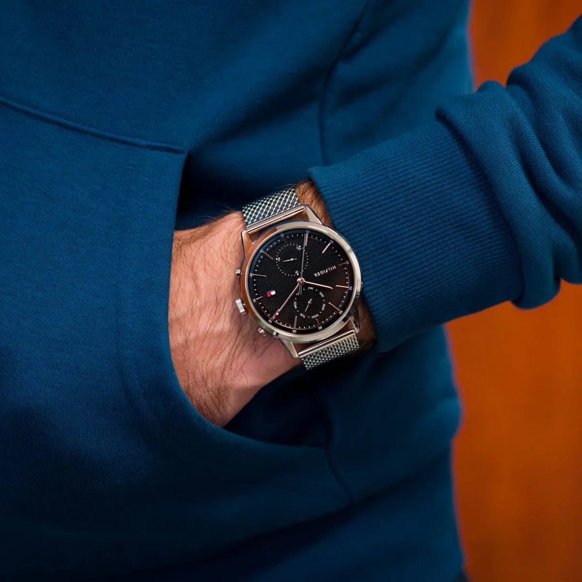 Tommy Hilfiger 1710433 watch on wrist with blue jacket