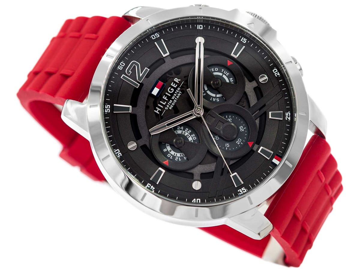 Angled view of Tommy Hilfiger Luca watch showing dial and red strap detail