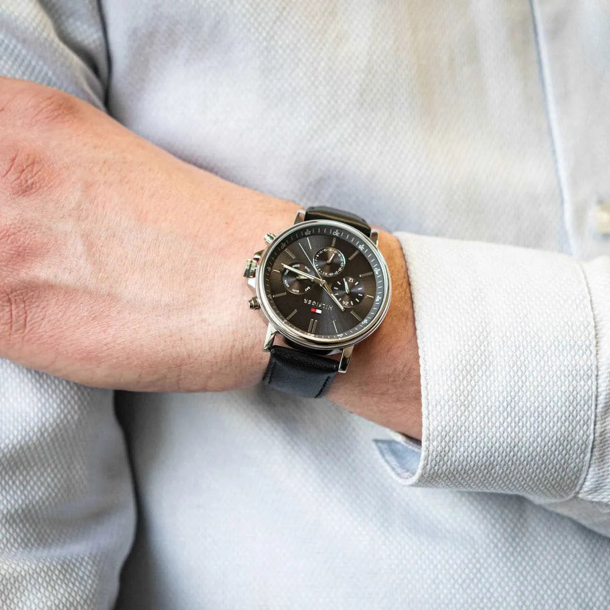 Tommy Hilfiger chronograph watch on wrist with silver case and dark dial