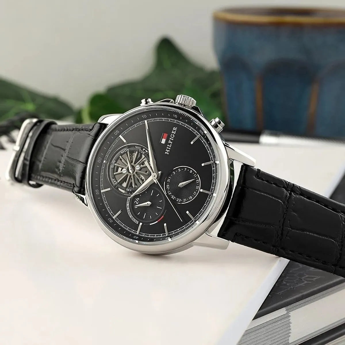 Tommy Hilfiger Stewart watch angled flat lay view showing dial design and leather strap
