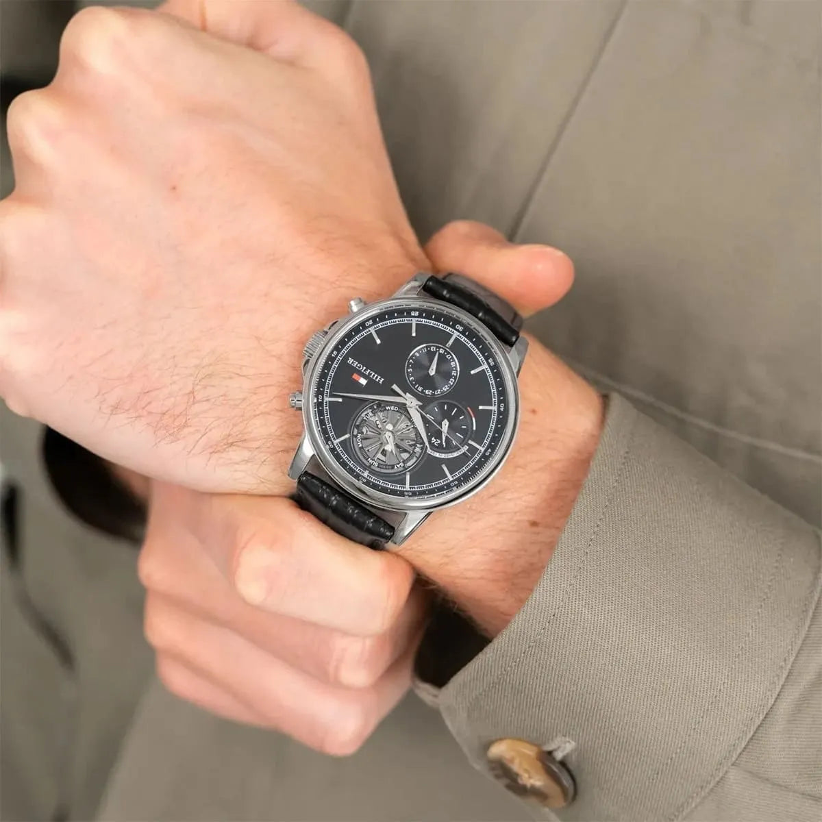 Tommy Hilfiger Stewart watch worn on male wrist in formal dress setting