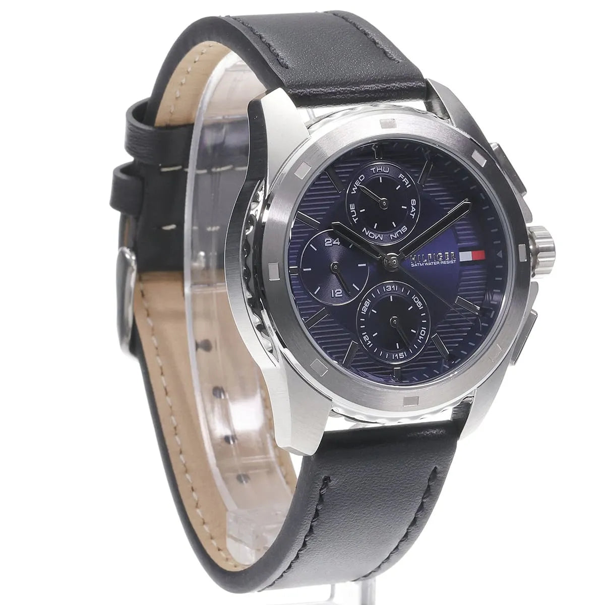 Tommy Hilfiger chronograph watch angled view with navy dial and tan leather strap lining visible