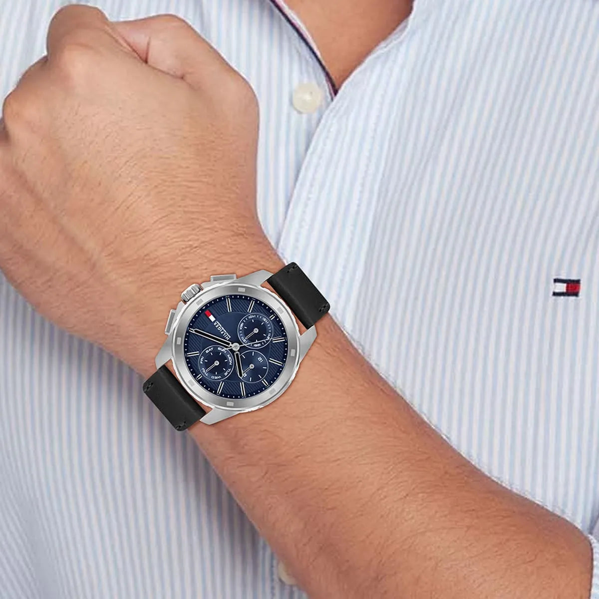Tommy Hilfiger chronograph watch on wrist with navy dial and black leather band in use