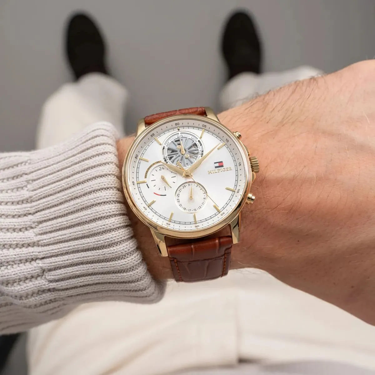 Tommy Hilfiger STANCE chronograph watch held in hand with product tag visible