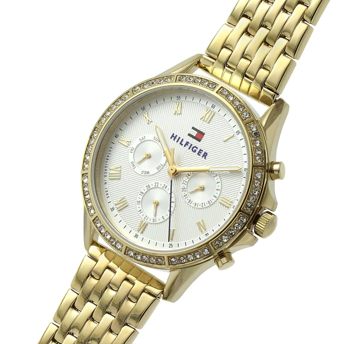 Tommy Hilfiger Ari women's watch worn on wrist, displaying white dial and crystal bezel detail