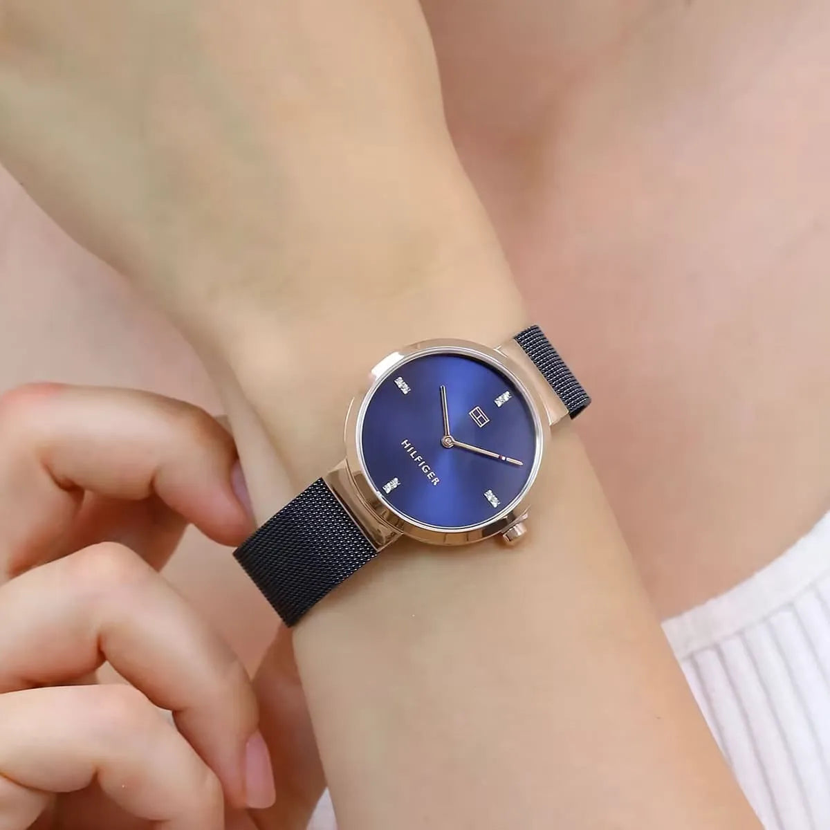 Tommy Hilfiger Liberty watch on female wrist showing blue dial and mesh strap