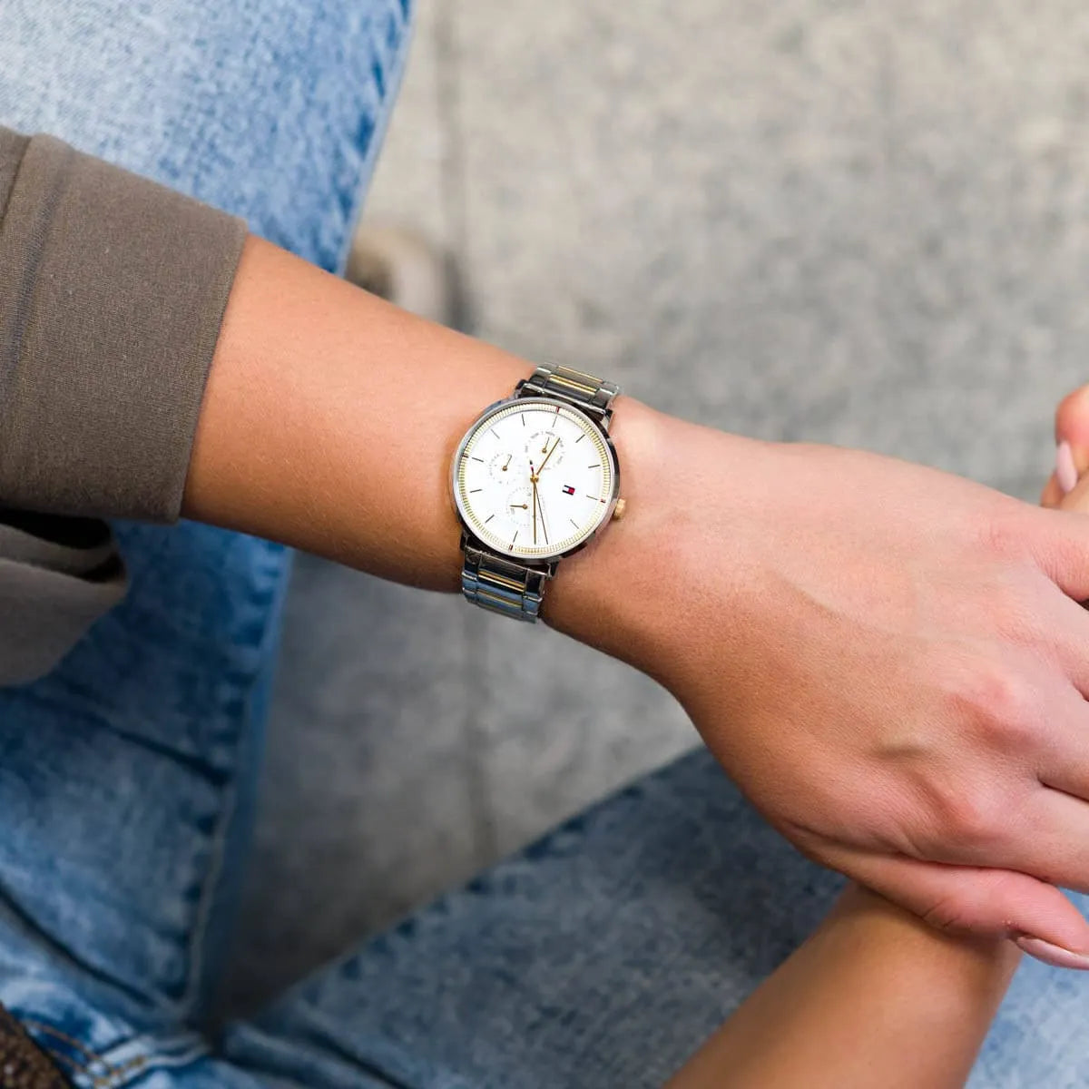 Tommy Hilfiger Jenna watch worn on wrist with silver dial and mixed metal band
