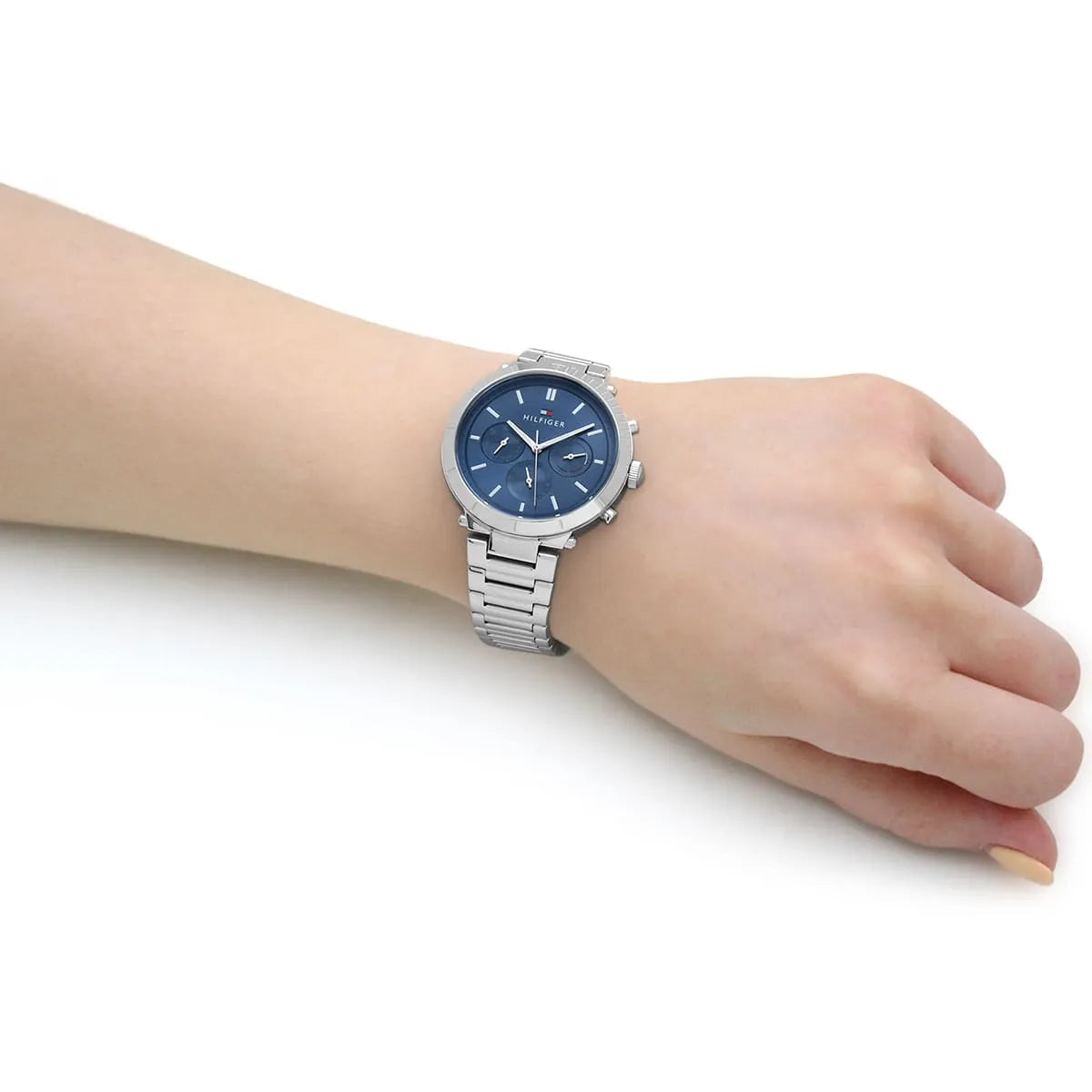 Tommy Hilfiger women's chronograph watch worn on wrist with blue dial and metal bracelet