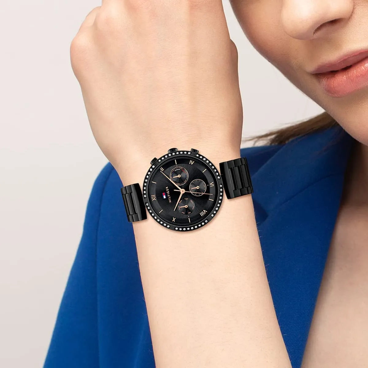 Tommy Hilfiger women's black dial watch with crystal bezel shown on wrist