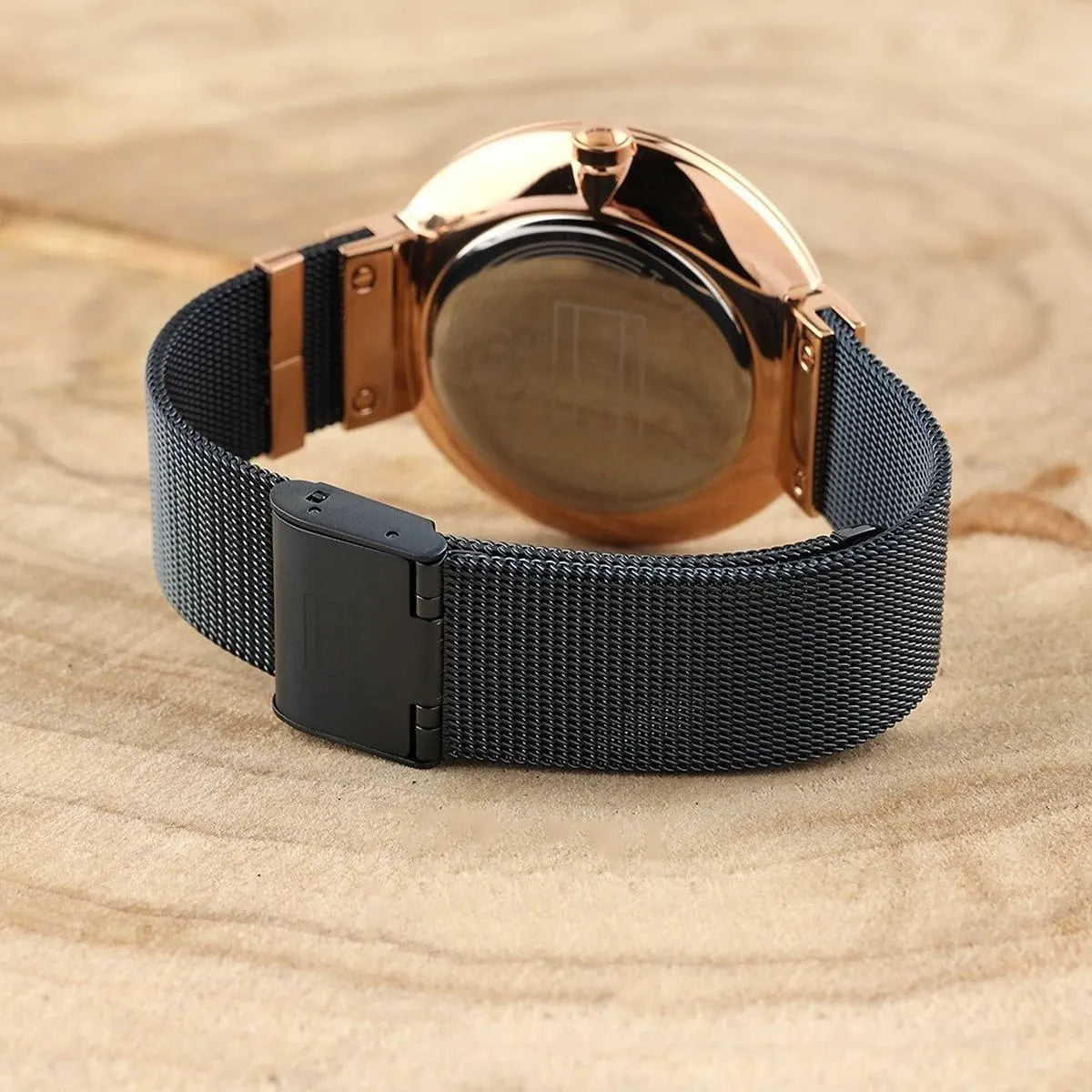 Tommy Hilfiger watch caseback displayed on sand