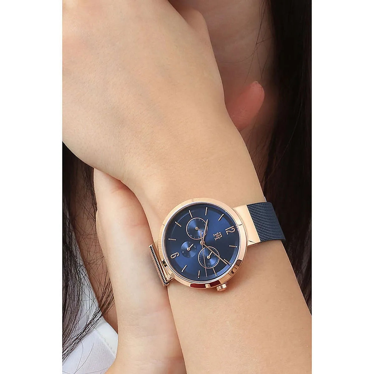 Tommy Hilfiger women's watch on wrist showing blue dial and mesh bracelet
