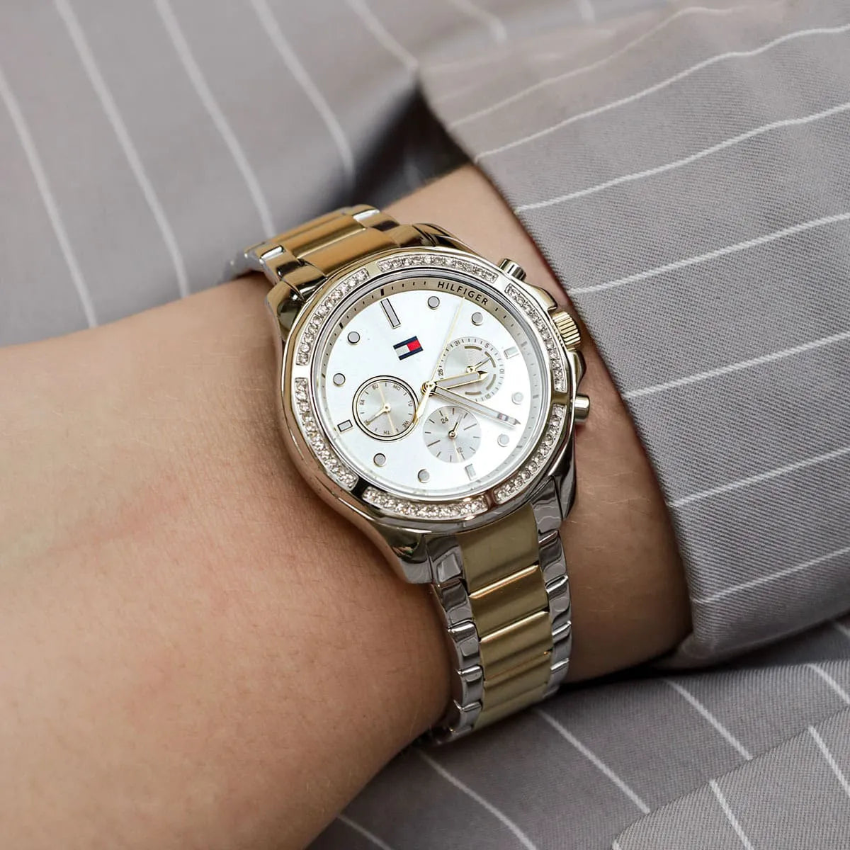 Tommy Hilfiger women's watch worn on wrist showing two-tone bracelet and silver dial