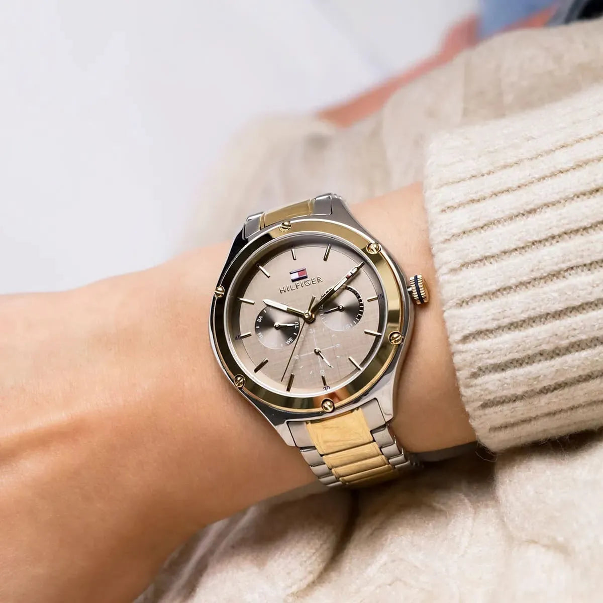 Tommy Hilfiger Lexi watch on wrist showing two-tone bracelet and light dial