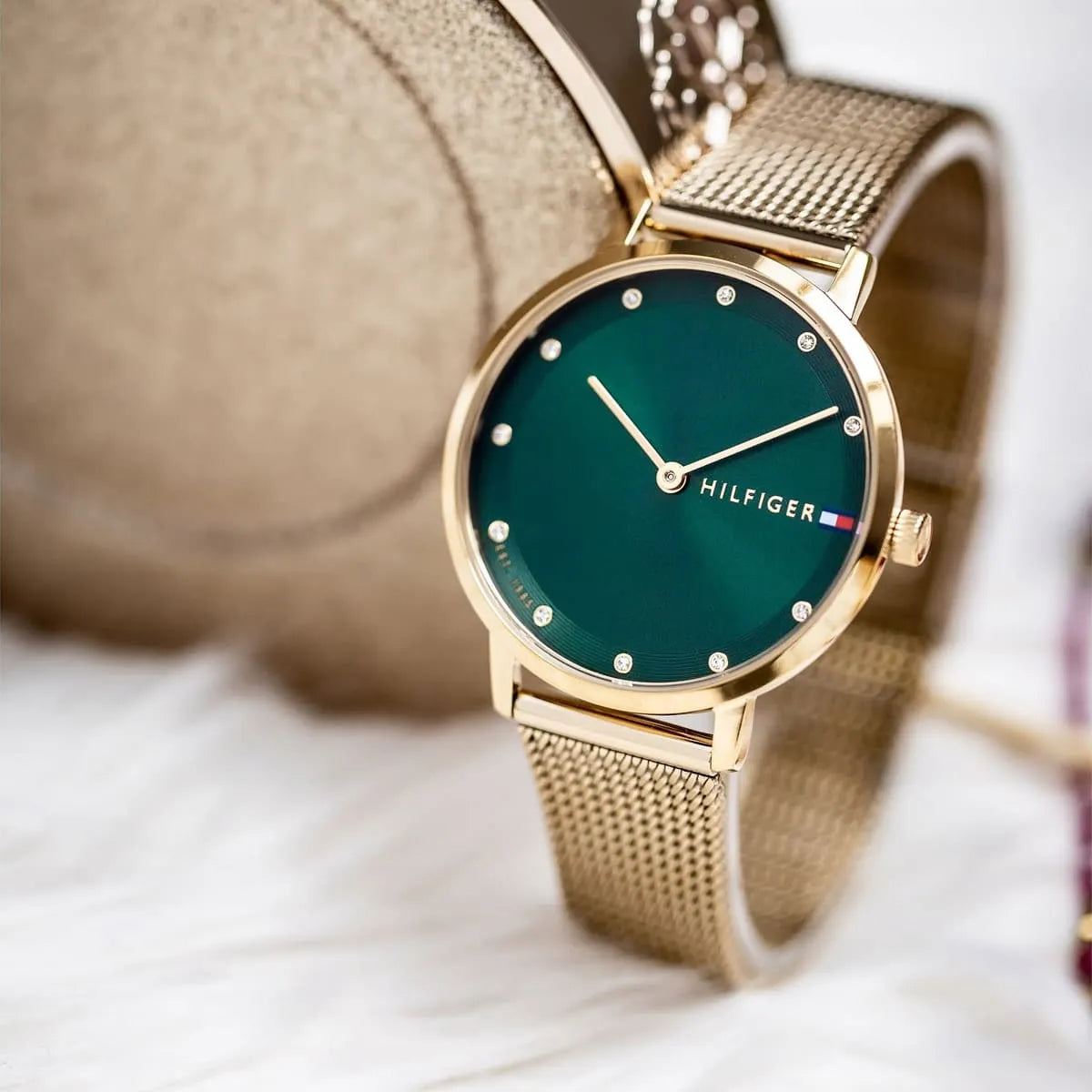 Tommy Hilfiger Pippa watch worn on wrist showing green dial and mesh bracelet