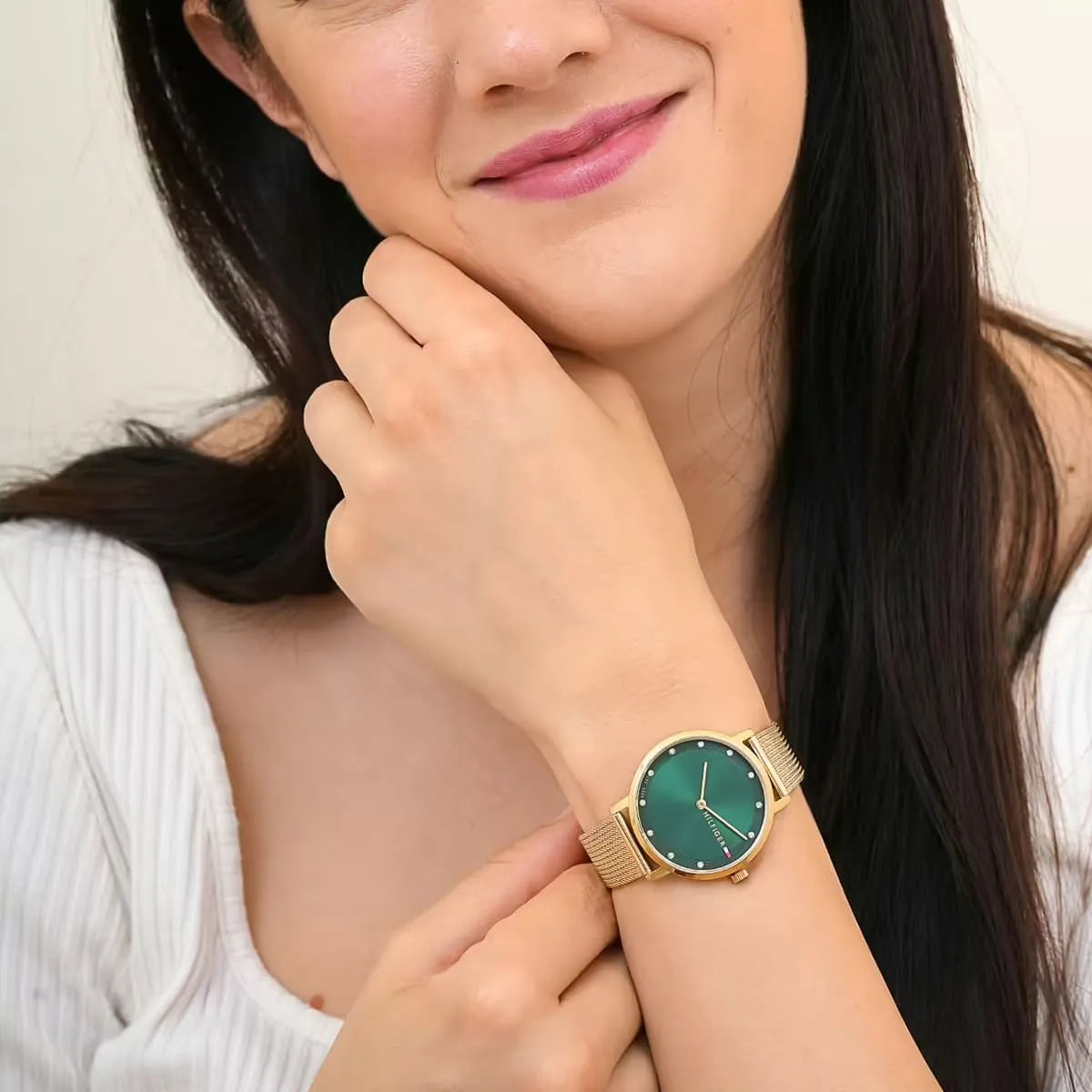 Woman wearing Tommy Hilfiger Pippa watch with green dial on wrist