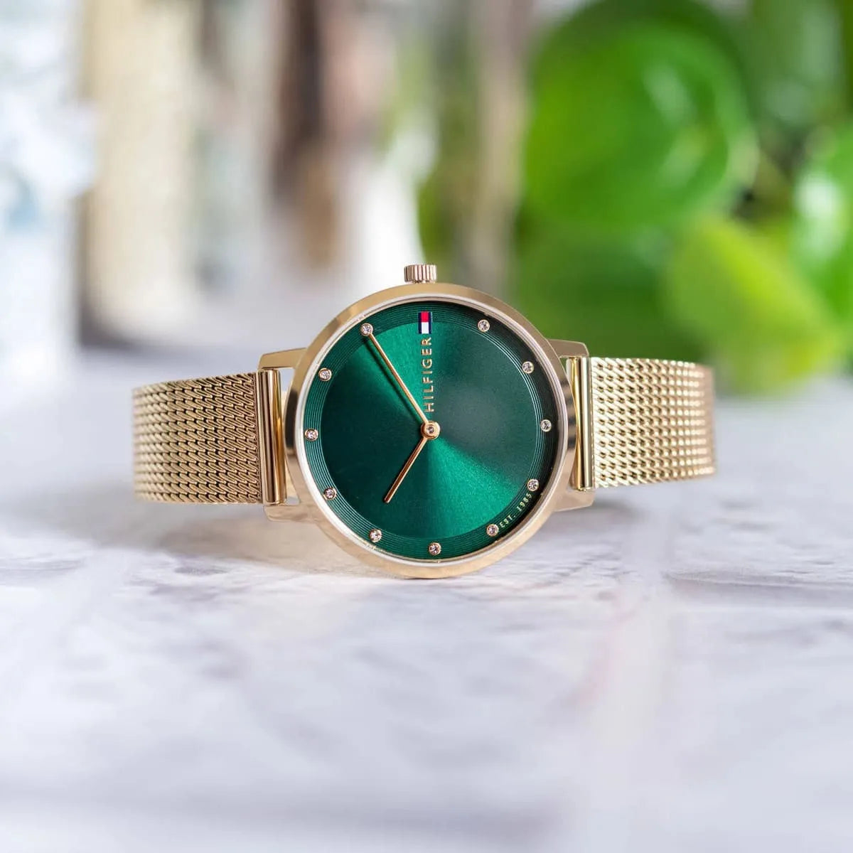 Tommy Hilfiger Pippa women's watch with green dial and gold mesh bracelet outdoor setting