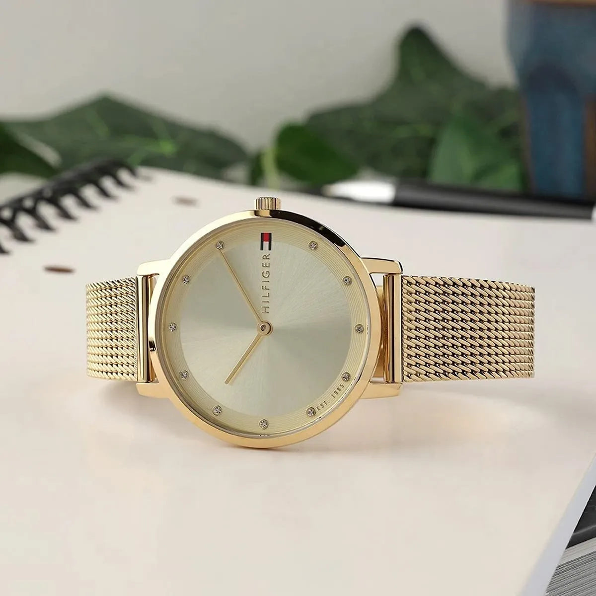 Tommy Hilfiger Pippa gold watch worn on wrist in lifestyle setting