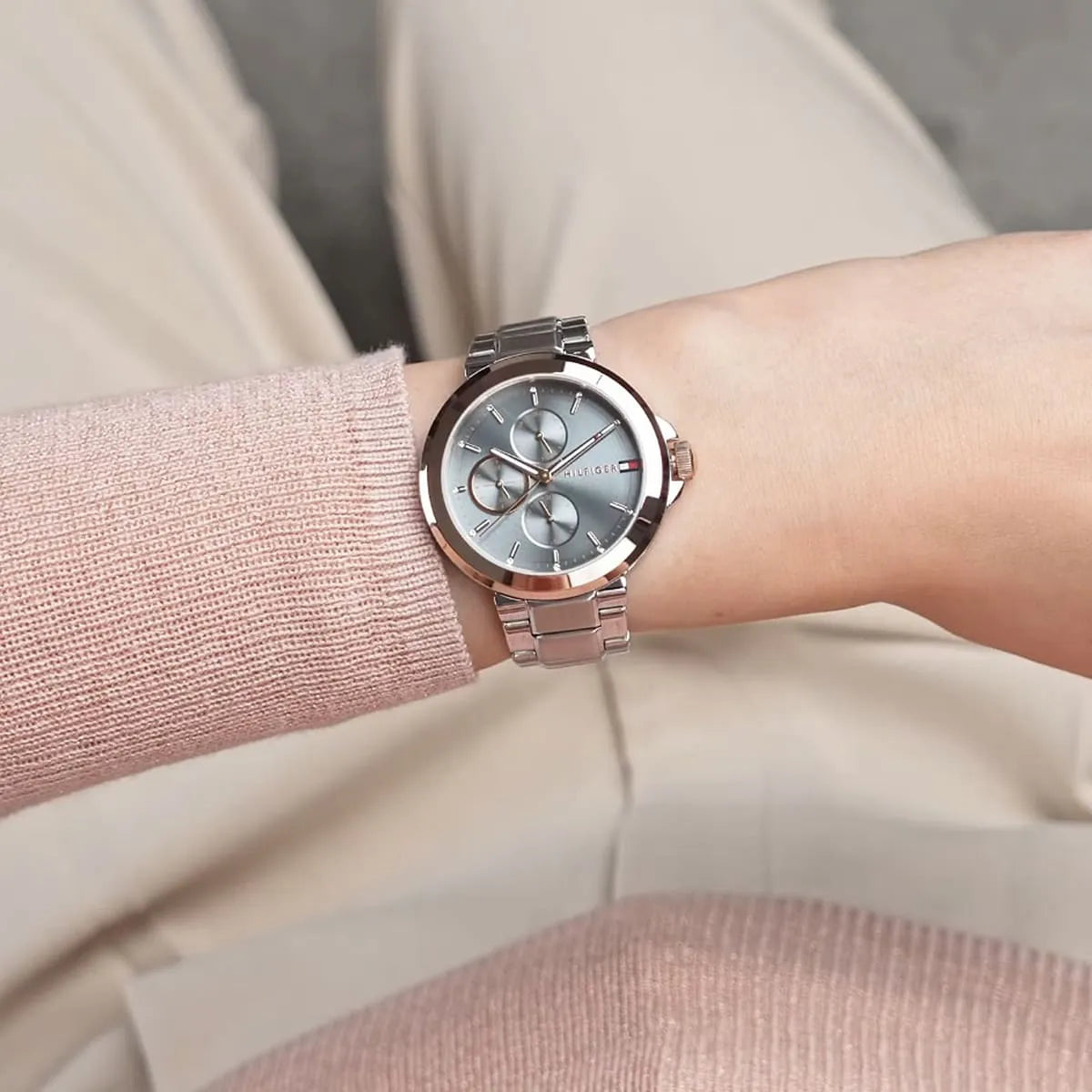 Tommy Hilfiger women's watch worn on wrist with blue dial and rose gold bezel