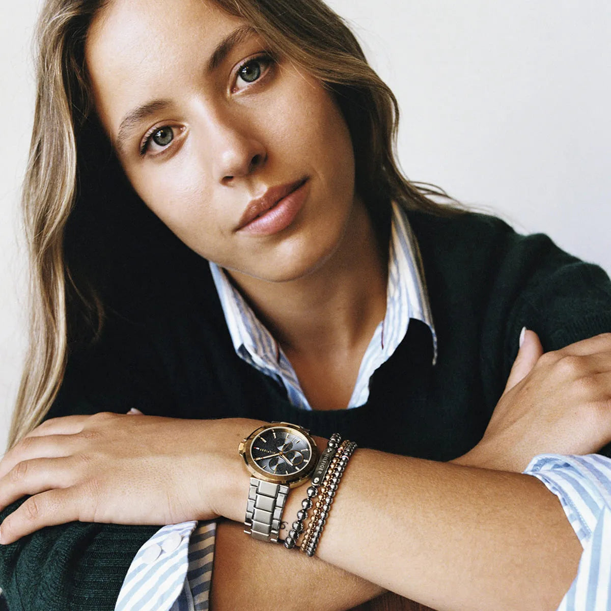 Woman wearing Tommy Hilfiger watch with blue dial and metal bracelet