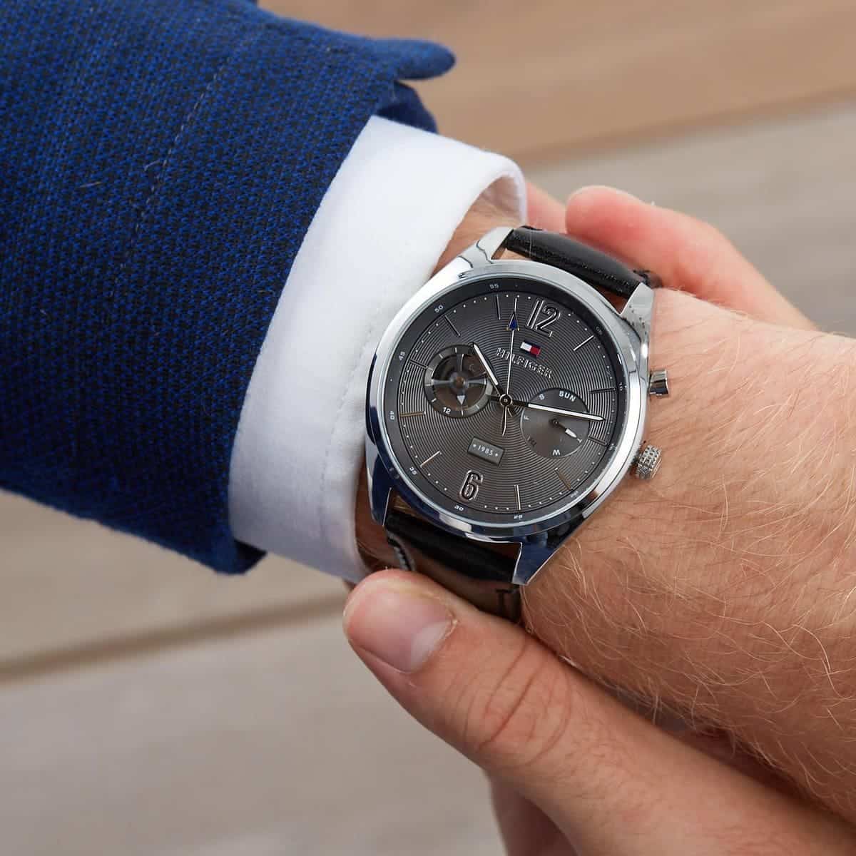 Tommy Hilfiger Deacan watch worn on wrist with navy blazer and white shirt